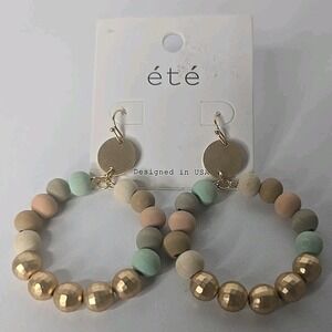Wood Beaded Hoop Earrings with gold accents by the brand été Boho